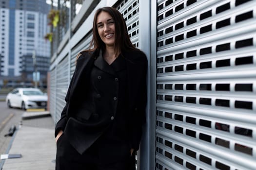 young adult woman in an urban environment on the background of the business district of the city.