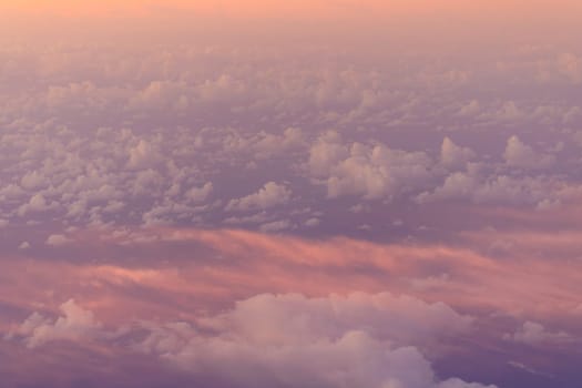 Hazy pink glow and clouds at sunrise in upper atmosphere. High quality photo