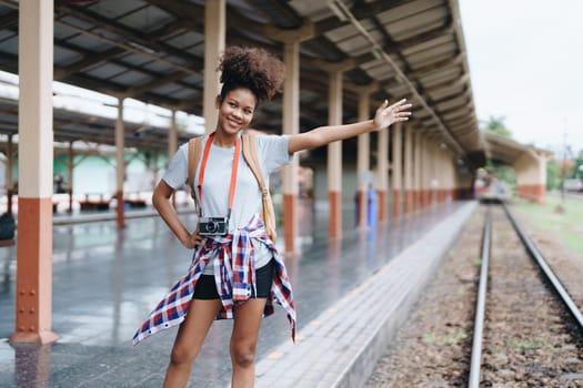 Tourists african american are showing happy expressions while waiting for their journey in the train station