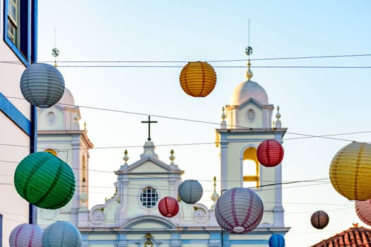 Church tower in the streets of the city of Diamantina decorated with colorful lanterns and light fixtures