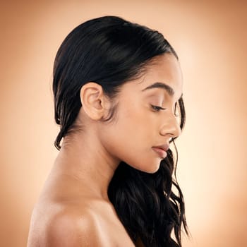 Profile, texture and woman with hair care, salon treatment and wellness against a brown studio background. Female person, girl and model with ideas, aesthetic and skincare with growth and self care.