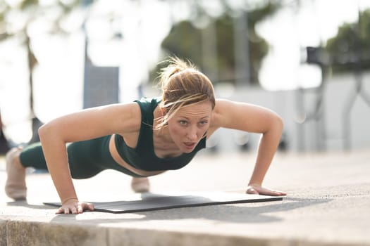 Adult sportive woman with no make up doing push ups. Mid shot