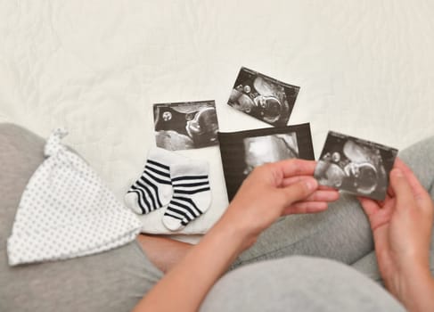 Pregnant woman holding ultrasound image