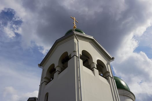 Photo of Orthodox church, bottom view of green domes with golden crosses.