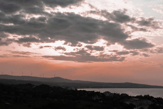 Abstract background sky Dawn Sunset Contrast dark shadow bright cloud sun orange silhouette above the mountains near the sea.
