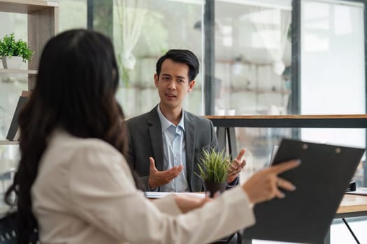 Two businessmen discussing some documents company. Group business making plans together.