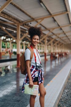 Asian teenage girl african american traveler dressed in casual wear holding map and searching right direction of route