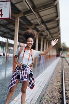 Tourists african american are showing happy expressions while waiting for their journey in the train station