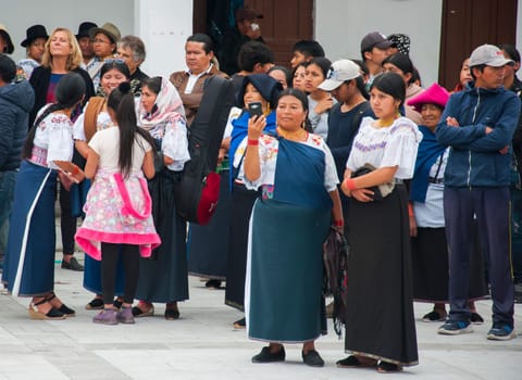 Otavalo, Ecuador - 24 de junio de 2023: indigenous woman recording with her cell phone the inti raymi event in otavalo, ecuador. High quality photo