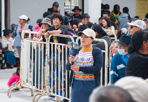 Otavalo, Ecuador - 24 de junio de 2023: indigenous reporter covering inti raymi event. High quality photo