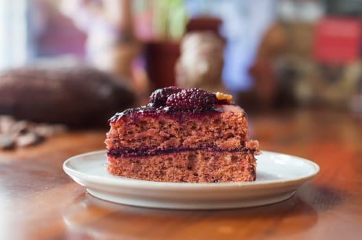 piece of forest fruit and blackberry cake exposed in a cafeteria. High quality photo
