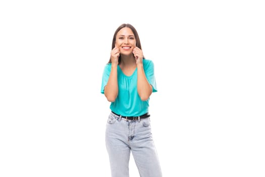 30 year old attractive brunette woman with flowing straight hair put on a blue T-shirt and jeans.