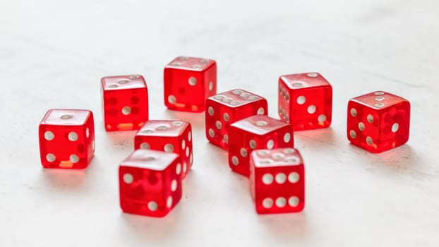 Ten red translucent craps dices on white board showing different numbers.
