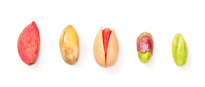 Top down view, pistachios in different stages from raw, through roasted and salted to peeled green, isolated on white background.