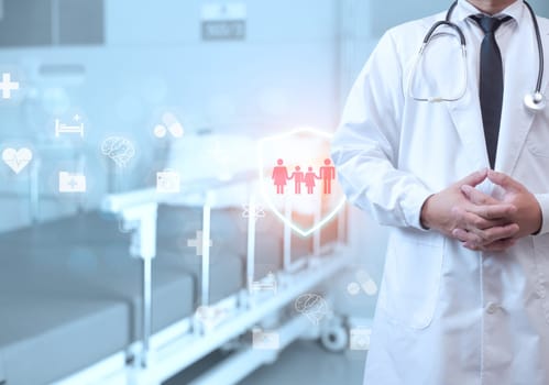 A doctor in a lab coat is standing on the background inside a hospital. Medical concept. Medical information search concept. The concept of treating disease. Insurance concept.