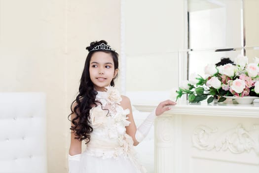 Image of lovely tanned girl posing in elegant white dress