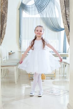 Image of amusing little girl posing in hotel restaurant
