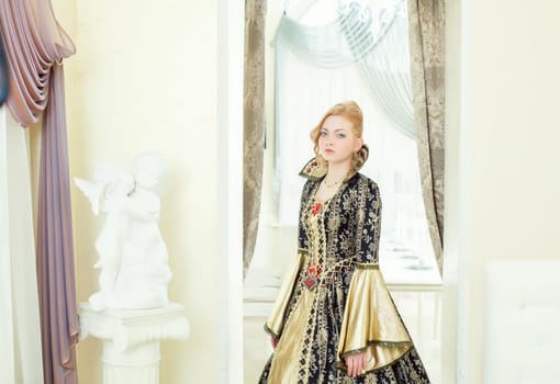 Beautiful young woman posing in deluxe king costume