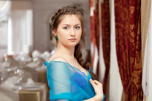 Image of elegant young girl posing in restaurant