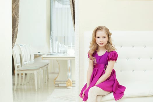 Image of smiling cute girl posing in smart purple dress