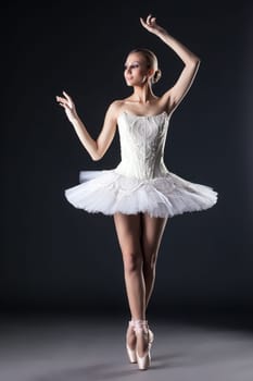 Image of attractive female ballet dancer posing in studio