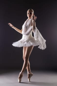 Image of adorable contemporary ballerina dancing in studio