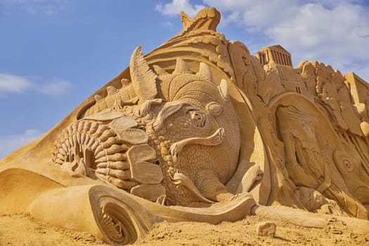 Sondervig, Denmark, May 21, 2023: Sand Sculpture Festival. Charybdis devouring ships