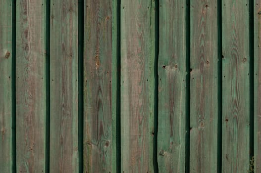 Old vintage wooden wall with color peeling paint for background.