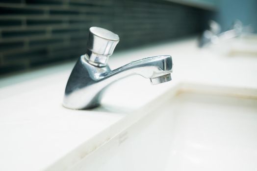 Luxury faucet on a white sink in the bathroom