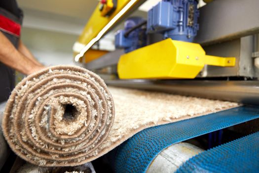 Man worker cleaning carpet on automatic washing machine equipment and dryer in the Laundry room