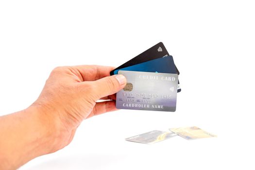 Human hand holding group of bank credit cards on white background, use for business and finance concepts.