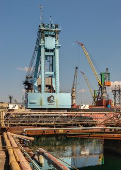 Chernomorsk, Ukraine. 21.03.2021. Large shipyard crane in the Chernomorsk Shipyard on a sunny spring day