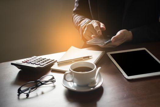 Business man working on digital tablet on wood table