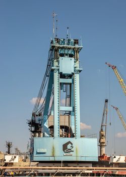 Chernomorsk, Ukraine. 21.03.2021. Large shipyard crane in the Chernomorsk Shipyard on a sunny spring day