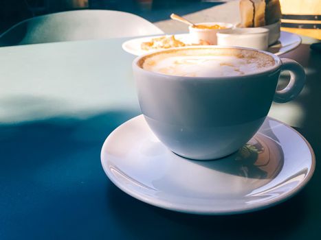 Cappuccino in summer cafe outdoors.