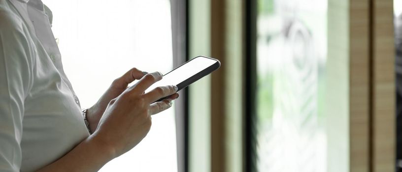 Close up hand of woman using smartphone, texting text message, hipster touch screen on smartphone light bokeh, girls using in hands cellphone close up, online internet.