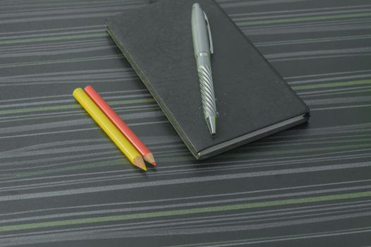 Pen and notebook on office table. Table top view. Corporate business background.