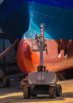 Chernomorsk, Ukraine. 21.03.2021. Painting the bottom of the ship at the dry dock of the Chernomorsk Shipyard