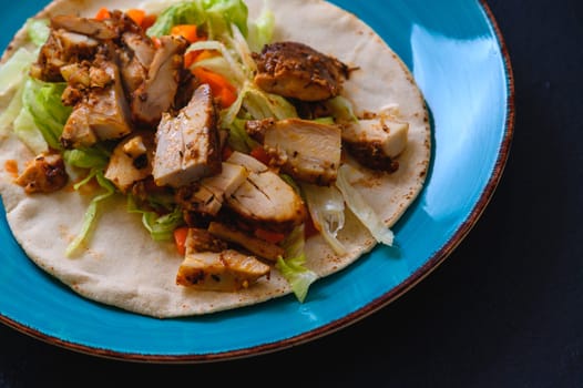 Chicken doner kebab, Turkish style doner kebab sandwich on homemade pita bread with fresh salad and homemade chili sauce and garlic yogurt sauce.