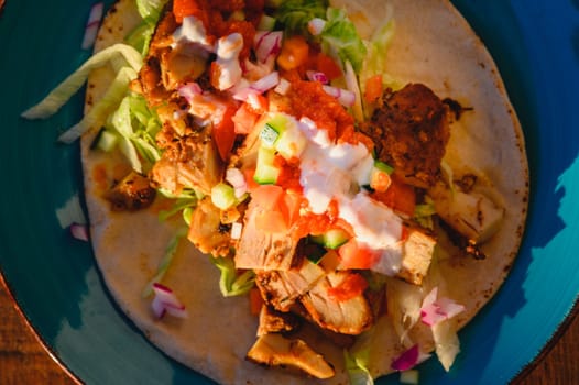 Chicken doner kebab, Turkish style doner kebab sandwich on homemade pita bread with fresh salad and homemade chili sauce and garlic yogurt sauce.