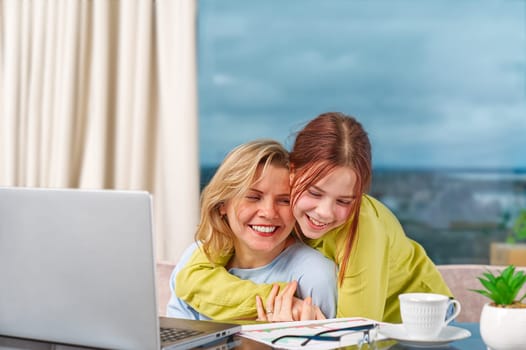 Mother with daughter working from home. Businesswoman mother woman with daughter trying to working. home office, remote work, mom while working from home concept