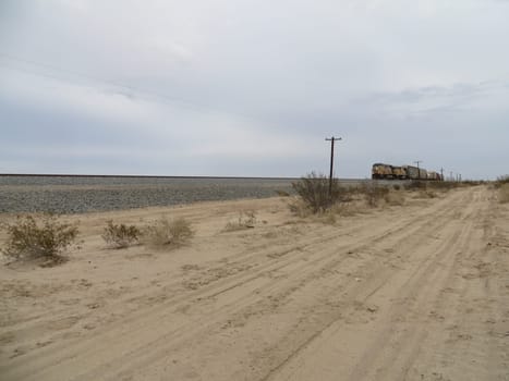 Far Away Freight Train Coming through the California Desert . High quality photo