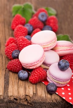 Macaroon with raspberries cookies on a wooden background