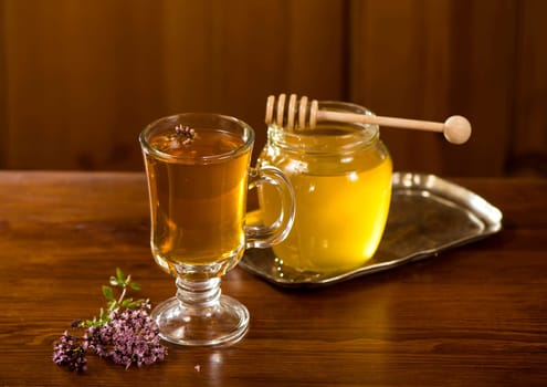 bouquet of wildflowers, honey and tea on the old board.