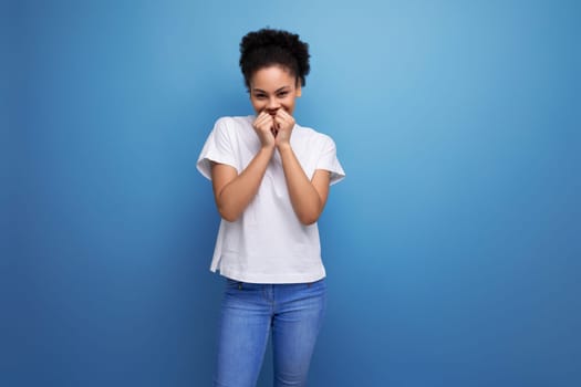 beautiful young swarthy woman with fluffy curly hair, dressed in a white t-shirt. corporate clothing.