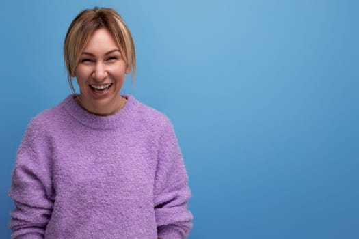 smiling stylish blond young woman in a casual look with a good mood on a bright background with copy space.