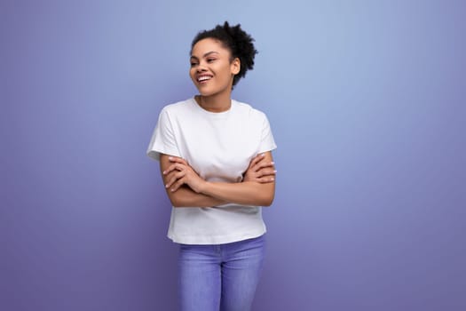 beautiful young swarthy woman with porous curly hair, dressed in a white T-shirt without a pattern.