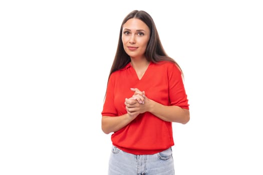 portrait of well-groomed brunette woman with straight hair in red t-shirt and jeans isolated studio background with copy space.