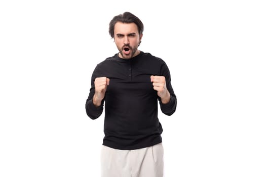 close-up portrait of a young 30 years old bearded well-groomed brunette with a chic stylish hairstyle in a black sweater with a mockup for identity and branding.