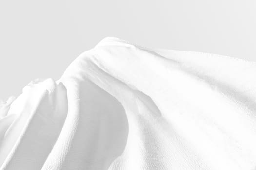 Background texture of crumpled white fabric on a light background with space for text